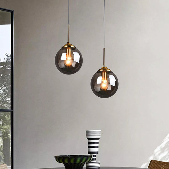 Sleek Brass Pendant Lamp with Amber/Smoke Glass Shade – Perfect for Dining Room Ceilings
