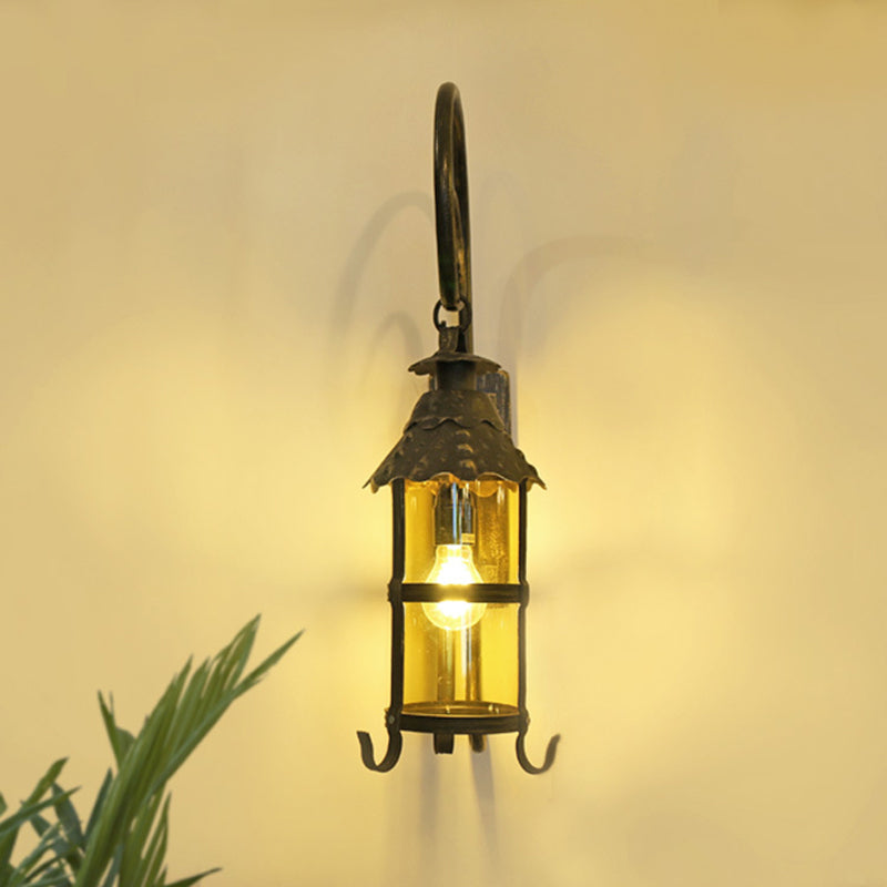 Rustic Lantern Wall Mounted Light Fixture with Scroll Arm in Antique Bronze