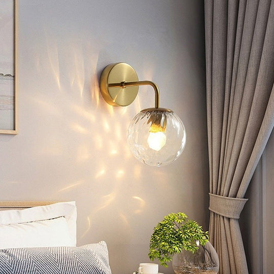 Minimalist Glass Ball Wall Lamp with Ripple Effect and Bent Arm in Black/Gold - Ideal for Bedroom Lighting