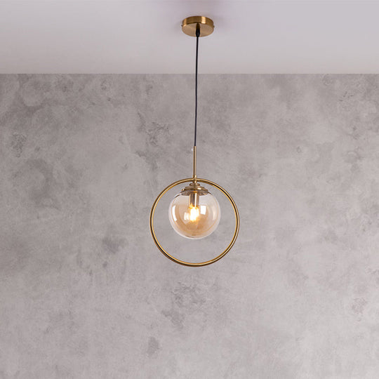 Postmodern Glass Pendant Light with Brass Ring for Bedroom - Single-Bulb Globe Down Lighting in Clear, Amber, and Smoke Grey