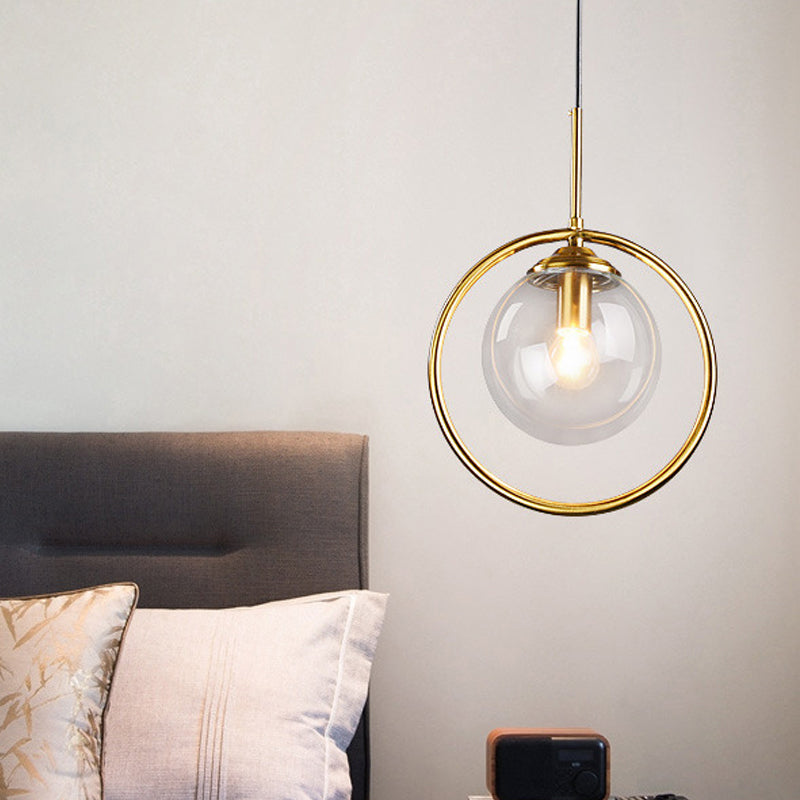 Postmodern Glass Pendant Light with Brass Ring for Bedroom - Single-Bulb Globe Down Lighting in Clear, Amber, and Smoke Grey