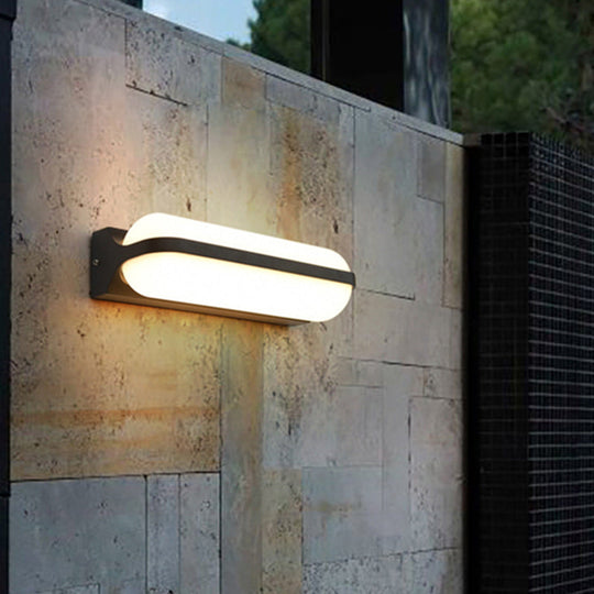 Modern Black Acrylic Wall Sconce with Flush Capsule Design and Half-Bulb Mounting