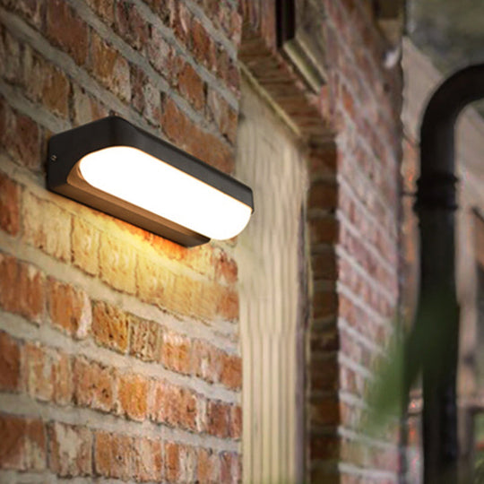 Modern Black Acrylic Wall Sconce with Flush Capsule Design and Half-Bulb Mounting