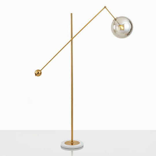 Postmodern Brass Plated Balance Arm Floor Lamp with Glass Spherical Shade - Stylish Metal Stand-Up Light, 1-Light