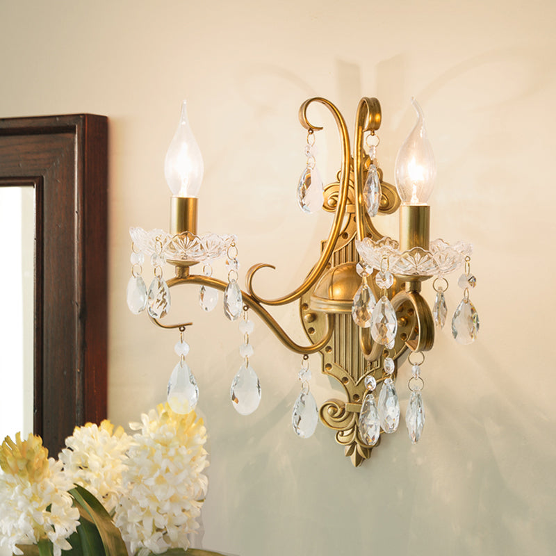 Traditional Crystal Candle Wall Sconce with Antiqued Brass Finish and Scroll Arm