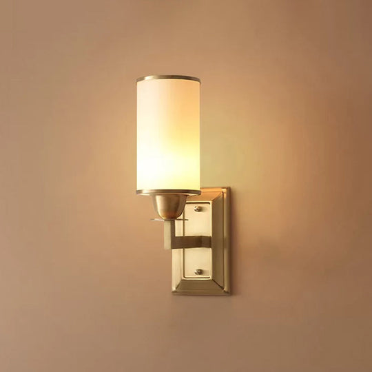 1-Light White Glass Wall Sconce in Traditional Brass - Elegant Cylindrical Dining Room Light