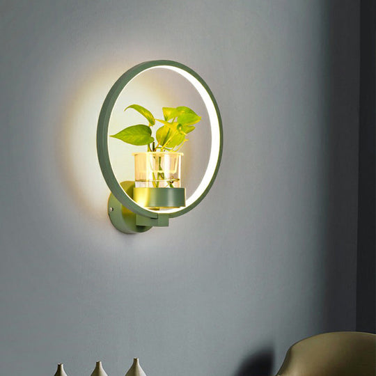 Modern Metal Wall Sconce with Artistic Loop Design and Clear Glass Plant Pot