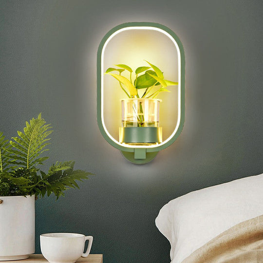 Modern Metal Wall Sconce with Artistic Loop Design and Clear Glass Plant Pot