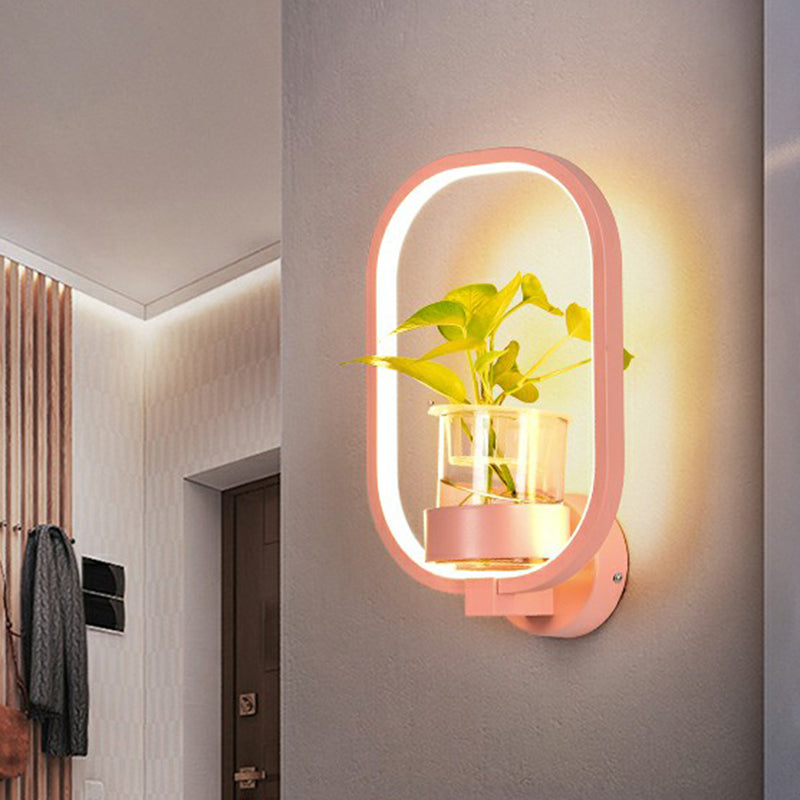 Modern Metal Wall Sconce with Artistic Loop Design and Clear Glass Plant Pot