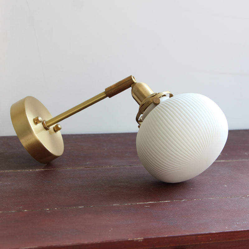 Brass Pivot Joint Foyer Sconce: Round Ribbed Glass Wall Light with White Simplicity (1 Bulb)