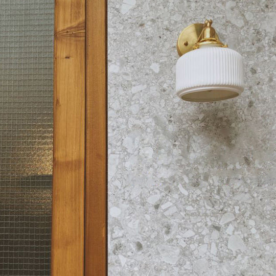 Brass Pivot Joint Foyer Sconce: Round Ribbed Glass Wall Light with White Simplicity (1 Bulb)
