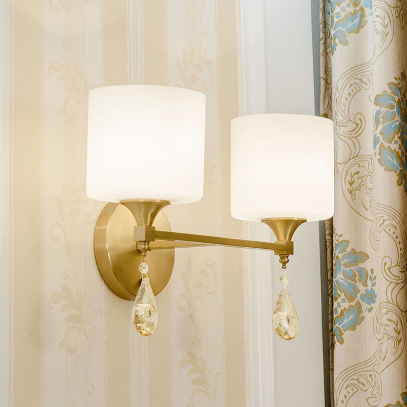 Modern Milk Glass Wall Sconce with Brass Finish and Amber Crystal Draping