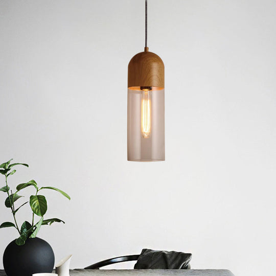 Modern Clear Glass Pendant Light: Sleek Half-Capsule Design, Wood Fixture for Bedroom