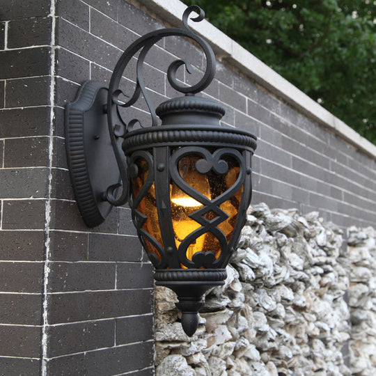 Courtyard Wall Light Fixture: Elegant Urn Shape, One Amber Glass Light, Black Mount