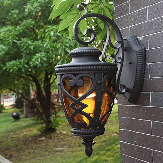 Courtyard Wall Light Fixture: Elegant Urn Shape, One Amber Glass Light, Black Mount